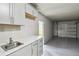 Well-organized garage with ample storage space, sink and a clean, epoxy-coated floor, perfect for projects at 1514 Pelican St, Longwood, FL 32750