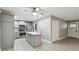 Open kitchen featuring gray cabinetry, stainless steel appliances, island, and wood look flooring at 1514 Pelican St, Longwood, FL 32750