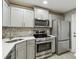 Modern kitchen featuring stainless steel appliances, granite countertops, and ample cabinet space at 1514 Pelican St, Longwood, FL 32750