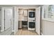 Convenient laundry closet with stacked washer and dryer, storage cabinet, desk space and storage, located off of bedroom at 1514 Pelican St, Longwood, FL 32750
