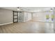 Living area with wood look flooring, modern barn door and lots of natural light at 1514 Pelican St, Longwood, FL 32750