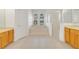 Bright bathroom features a soaking tub, glass shower, double sinks, and wood cabinetry for a serene experience at 1521 Gants Cir, Kissimmee, FL 34744