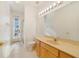 Bright bathroom featuring neutral tile, a light wood vanity, and a glass-enclosed shower at 1521 Gants Cir, Kissimmee, FL 34744