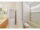 Bright bathroom featuring a double vanity, tile floors, and a shower-tub combination at 1521 Gants Cir, Kissimmee, FL 34744