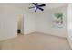 An empty room with a ceiling fan and view from window at 1521 Gants Cir, Kissimmee, FL 34744
