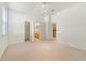Vacant bedroom with white walls, neutral carpet, and an open doorway leading to the en-suite bathroom at 1521 Gants Cir, Kissimmee, FL 34744