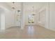 Bright living room with tile flooring, decorative lighting fixtures, and transom window above front door at 1521 Gants Cir, Kissimmee, FL 34744