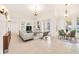 Bright living room featuring a neutral palette, built-in shelving, and a dining area with access to the outdoors at 1521 Gants Cir, Kissimmee, FL 34744