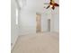 Cozy carpeted bedroom with a tray ceiling and a view of the hallway to the ensuite bathroom at 1521 Gants Cir, Kissimmee, FL 34744