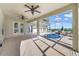 Spacious screened-in patio with brick flooring leads to the pool and outdoor entertainment area at 1521 Gants Cir, Kissimmee, FL 34744