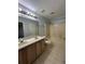 Bathroom featuring a double sink vanity and a bathtub with a shower at 15279 Sugargrove Way, Orlando, FL 32828