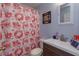 Bathroom features a decorative shower curtain and vanity with sink at 15279 Sugargrove Way, Orlando, FL 32828