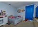 Standard bedroom with blue curtained window and basic furnishings at 15279 Sugargrove Way, Orlando, FL 32828