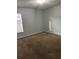 A bright bedroom with a carpeted floor and a window providing natural light at 15279 Sugargrove Way, Orlando, FL 32828