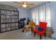 Bedroom with a ceiling fan, records and a red chair at 15279 Sugargrove Way, Orlando, FL 32828