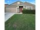 Charming single-story home with well-maintained front yard and attached garage at 15279 Sugargrove Way, Orlando, FL 32828