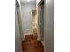 Hallway with wooden floors and three doors at 15279 Sugargrove Way, Orlando, FL 32828