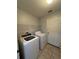 Bright laundry room featuring modern washer and dryer, tile floors, and storage at 15279 Sugargrove Way, Orlando, FL 32828