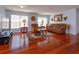 Well-lit living room with comfortable seating, hardwood floors, and bright neutral walls at 15279 Sugargrove Way, Orlando, FL 32828