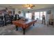 Bright living area with a pool table, large windows, and ample space for entertainment at 15279 Sugargrove Way, Orlando, FL 32828