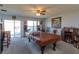 Spacious living area with a pool table, bar, and sliding glass doors leading to the backyard at 15279 Sugargrove Way, Orlando, FL 32828