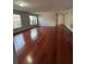 A bright living room features hardwood floors and plenty of natural light through the windows at 15279 Sugargrove Way, Orlando, FL 32828