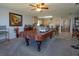 Open-concept living area featuring a pool table, bar, and seamless connection to the kitchen at 15279 Sugargrove Way, Orlando, FL 32828