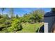 Expansive backyard with lush greenery, a black metal fence, mature trees offering plenty of shade at 1530 Lexington Av Ave, Davenport, FL 33837
