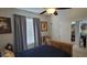Comfortable bedroom featuring a ceiling fan, window with blinds, and a wooden bed frame at 1530 Lexington Av Ave, Davenport, FL 33837
