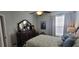 Serene bedroom with soft lighting, a comfortable bed, dresser with decor, and light paint at 1530 Lexington Av Ave, Davenport, FL 33837