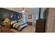 This bedroom features an accent wall, carpet floors, lamps, ceiling fan, and coordinated furniture at 1530 Lexington Av Ave, Davenport, FL 33837