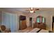A bedroom with a ceiling fan features carpet floors, blinds and an accent wall at 1530 Lexington Av Ave, Davenport, FL 33837