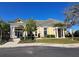 Exterior of clubhouse with white columns, neutral paint and tile roof surrounded by lush landscaping at 1530 Lexington Av Ave, Davenport, FL 33837