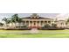 Clubhouse featuring classic architecture, manicured lawns, lush greenery, and brick pathway at 1530 Lexington Av Ave, Davenport, FL 33837