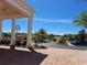 View of porte cochere entryway to clubhouse with tropical landscaping and ample parking at 1530 Lexington Av Ave, Davenport, FL 33837