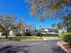 A community clubhouse with manicured landscaping and a bright blue sky on a sunny day at 1530 Lexington Av Ave, Davenport, FL 33837