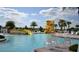 Resort-style community pool with fun water slides, palm trees, and lounge chairs for relaxation at 1530 Lexington Av Ave, Davenport, FL 33837