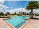 Inviting community pool with a fun water slide, surrounded by palm trees, and comfortable seating for residents at 1530 Lexington Av Ave, Davenport, FL 33837