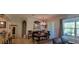 Bright dining room featuring elegant chandelier, large windows, and neutral wall color at 1530 Lexington Av Ave, Davenport, FL 33837