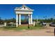 Community entrance featuring a charming white structure with columns and manicured landscaping at 1530 Lexington Av Ave, Davenport, FL 33837