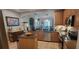An open kitchen showcases stainless steel appliances, wooden cabinets, granite countertops and an island at 1530 Lexington Av Ave, Davenport, FL 33837