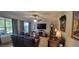 Inviting living room with comfortable leather seating, a ceiling fan, and large windows at 1530 Lexington Av Ave, Davenport, FL 33837
