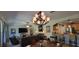 This open concept living room includes a kitchen with bar stool seating and dining table with chairs at 1530 Lexington Av Ave, Davenport, FL 33837