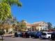 Exterior view of a clubhouse with parking lot surrounded by trees under a clear blue sky at 1530 Lexington Av Ave, Davenport, FL 33837