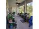 Covered outdoor patio with a ceiling fan, grill, and plenty of seating at 1530 Lexington Av Ave, Davenport, FL 33837