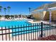 Community pool with surrounding lounge area, palm trees and a blue sky at 1530 Lexington Av Ave, Davenport, FL 33837