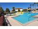 Large community pool with water slides, palm trees and comfortable lounge chairs at 1530 Lexington Av Ave, Davenport, FL 33837