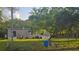Exterior of the home, featuring a spacious yard and a mature shade tree at 18168 Cedarhurst Rd, Orlando, FL 32820