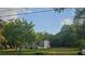 Exterior view of a home surrounded by lush greenery and an expansive lawn at 18168 Cedarhurst Rd, Orlando, FL 32820