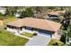 Aerial view of a single-story home with a screened in patio and driveway at 2072 Monterey Dr, Deltona, FL 32738